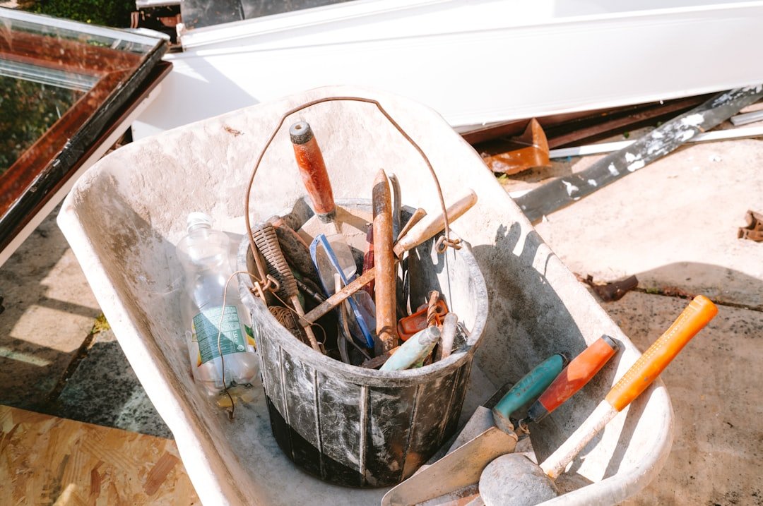 services-01 bucket-of-hand-tools-in-a-wheelbarrow-rbr6kt9xm7o